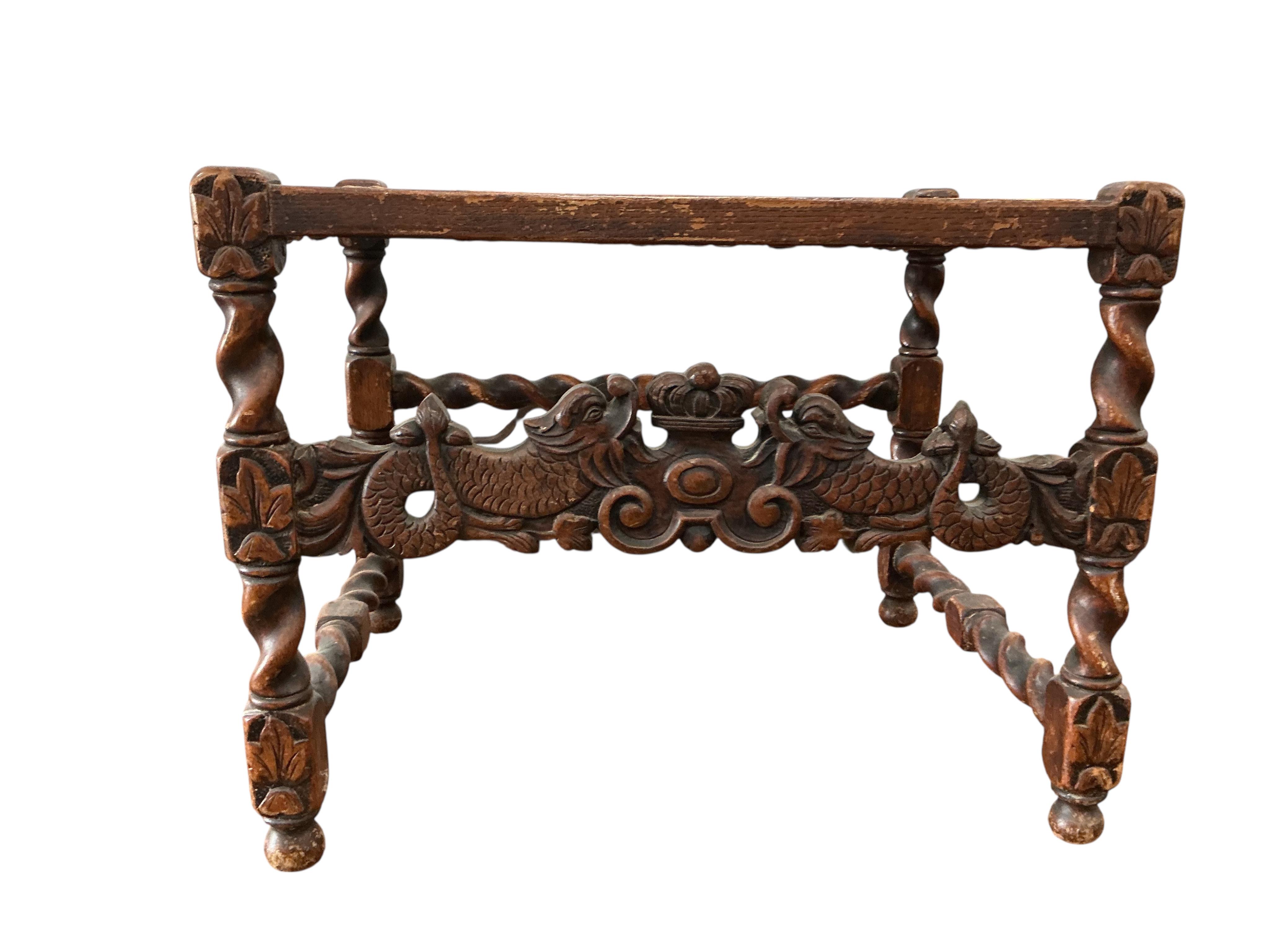 A Carolean style carved oak cane seat stool, width 63cm, depth 47cm, height 49cm